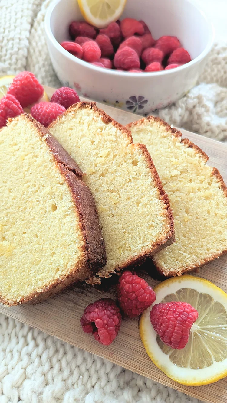 Lemon pound cake with lemons and raspberries